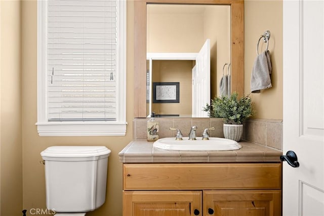 bathroom with toilet and vanity