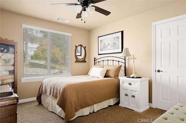 bedroom with light colored carpet, multiple windows, and visible vents