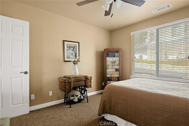 carpeted bedroom featuring visible vents, baseboards, and a ceiling fan