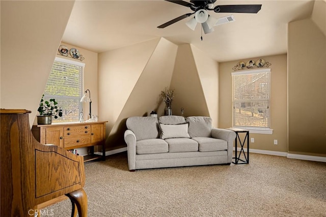 living area featuring baseboards, a ceiling fan, visible vents, and carpet floors