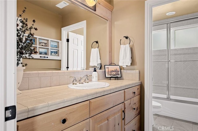 full bath featuring vanity, enclosed tub / shower combo, tile patterned flooring, toilet, and visible vents