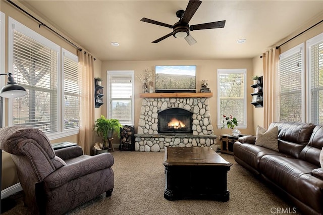 living room with ceiling fan, a fireplace, and carpet floors