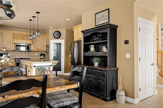 dining space with recessed lighting, light tile patterned floors, and baseboards
