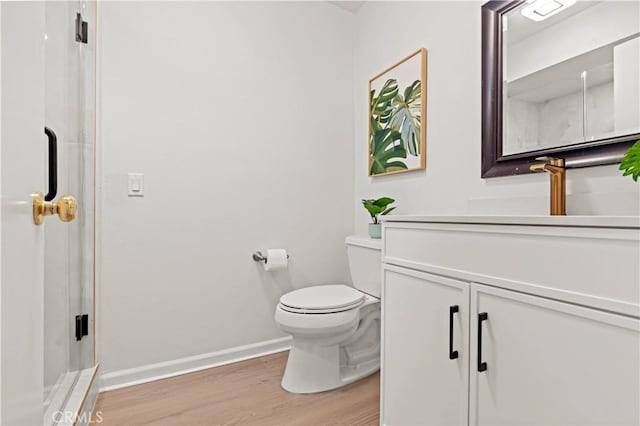 49 W Yale Loop Unit 26, Irvine, CA 92604 - bathroom featuring vanity, wood finished floors, baseboards, toilet, and a stall shower