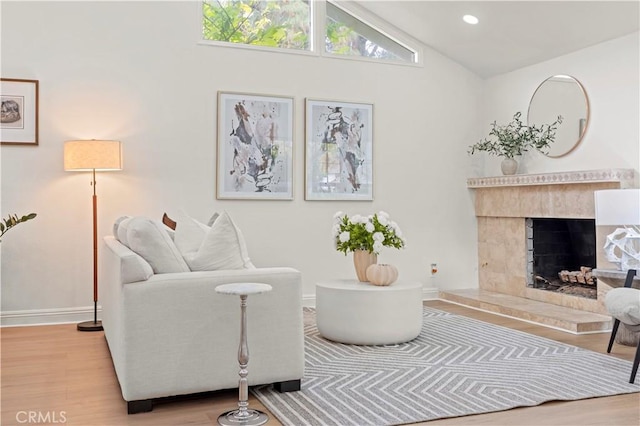 49 W Yale Loop Unit 26, Irvine, CA 92604 - living room with wood finished floors, lofted ceiling, baseboards, and a tile fireplace