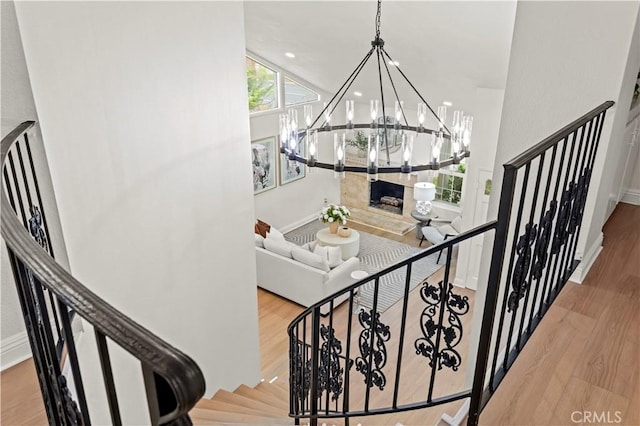 49 W Yale Loop Unit 26, Irvine, CA 92604 - stairway featuring a chandelier, wood finished floors, a towering ceiling, and baseboards