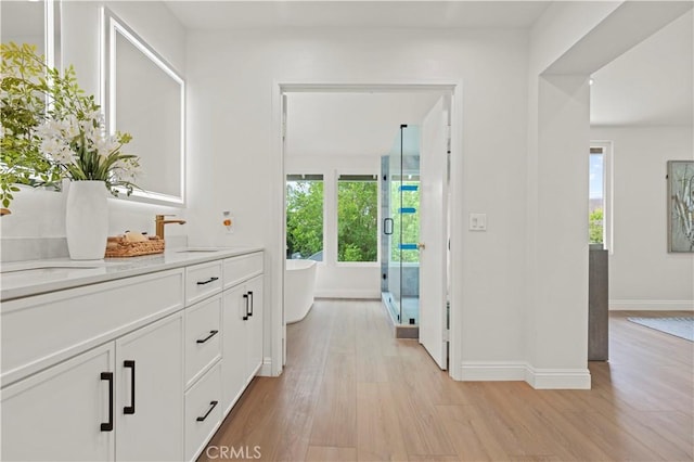49 W Yale Loop Unit 26, Irvine, CA 92604 - hallway with a sink, light wood-type flooring, and baseboards