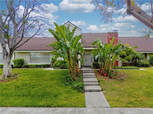 49 W Yale Loop Unit 26, Irvine, CA 92604 - view of front of house featuring a chimney and a front yard