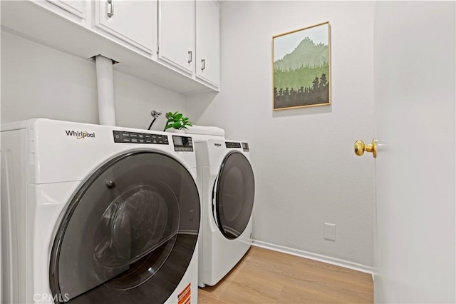 49 W Yale Loop Unit 26, Irvine, CA 92604 - laundry area featuring cabinet space, washing machine and dryer, light wood-type flooring, and baseboards