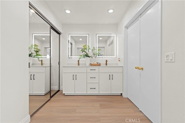 49 W Yale Loop Unit 26, Irvine, CA 92604 - full bath with double vanity, wood finished floors, and recessed lighting