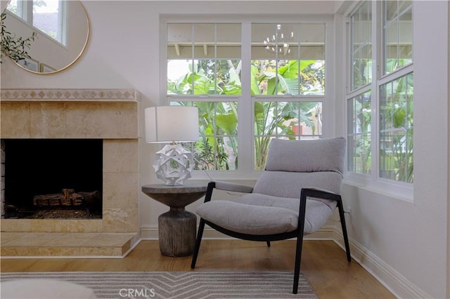 49 W Yale Loop Unit 26, Irvine, CA 92604 - sitting room featuring wood finished floors, baseboards, and a fireplace