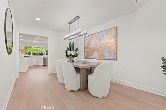 49 W Yale Loop Unit 26, Irvine, CA 92604 - dining area with light wood finished floors, baseboards, recessed lighting, and a chandelier
