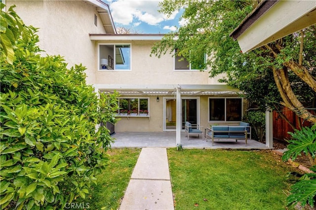 49 W Yale Loop Unit 26, Irvine, CA 92604 - rear view of property featuring stucco siding, a patio area, and an outdoor living space