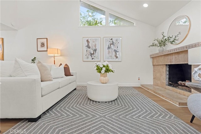 49 W Yale Loop Unit 26, Irvine, CA 92604 - living room featuring plenty of natural light, wood finished floors, a high end fireplace, baseboards, and high vaulted ceiling