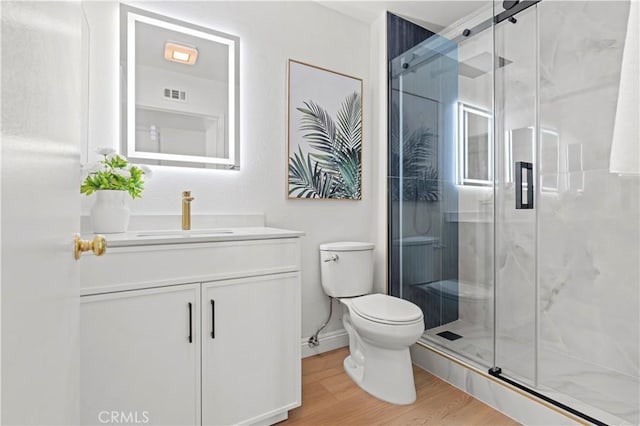 49 W Yale Loop Unit 26, Irvine, CA 92604 - bathroom featuring toilet, vanity, a shower stall, wood finished floors, and baseboards