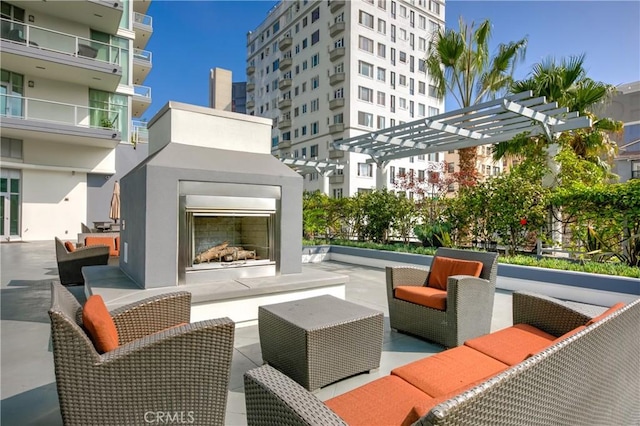 view of patio / terrace featuring a pergola and an outdoor living space with a fireplace