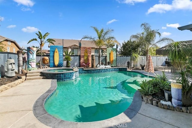 view of swimming pool with a pool with connected hot tub, a fenced backyard, and a patio area