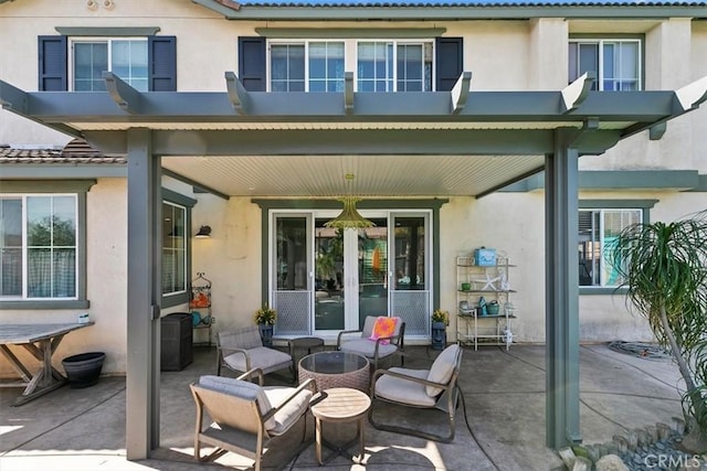rear view of house featuring a patio, stucco siding, and a tile roof