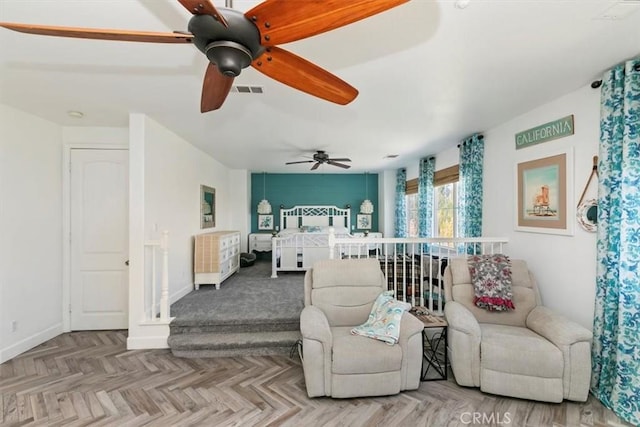 bedroom with visible vents, baseboards, and ceiling fan