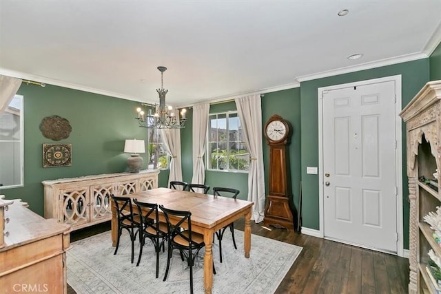 dining room featuring a chandelier, dark wood finished floors, baseboards, and ornamental molding