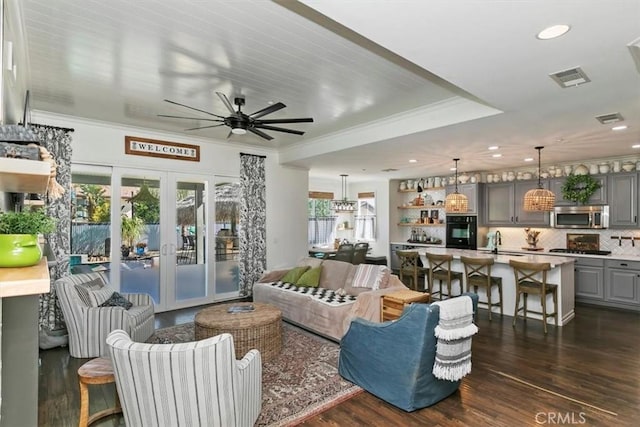 living room featuring french doors, ceiling fan, visible vents, and dark wood-style floors