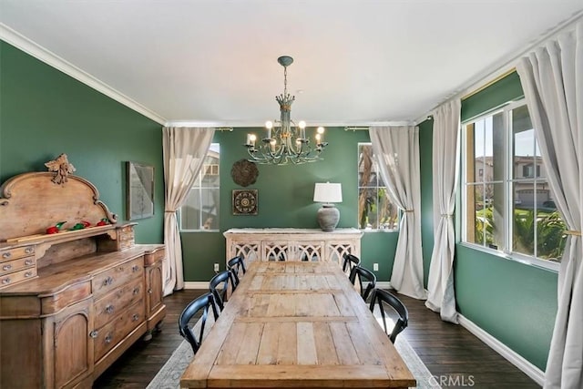dining space featuring crown molding, baseboards, a notable chandelier, and dark wood finished floors
