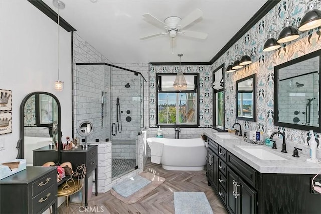 full bath featuring a shower stall, a ceiling fan, a sink, a freestanding bath, and wallpapered walls