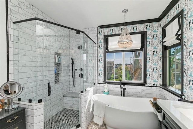 bathroom featuring a shower stall, vanity, a freestanding bath, and tile walls