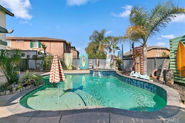 view of pool featuring a fenced backyard and a pool with connected hot tub