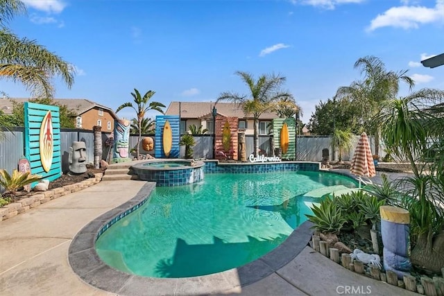 view of pool featuring a fenced backyard and a pool with connected hot tub