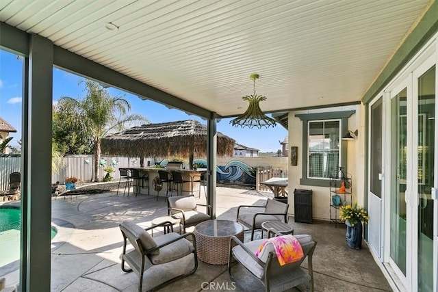 view of patio featuring a fenced backyard, a fenced in pool, and outdoor dry bar