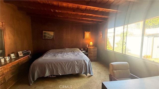 bedroom featuring wood ceiling, beam ceiling, carpet flooring, and multiple windows