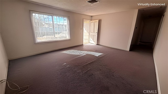 carpeted spare room featuring baseboards, visible vents, and a textured ceiling
