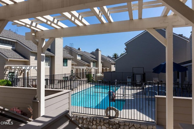 pool featuring a patio, a pergola, fence, and a residential view
