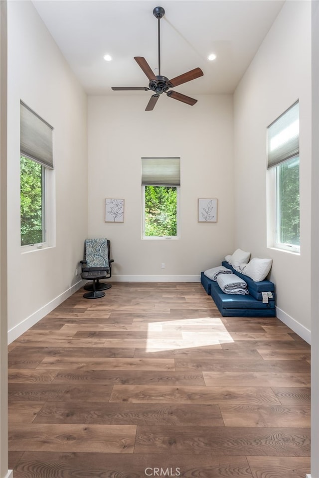 unfurnished room with baseboards, ceiling fan, and wood finished floors