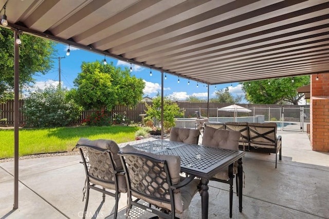 view of patio / terrace featuring a swimming pool, outdoor dining space, and a fenced backyard