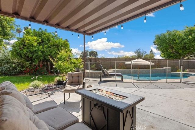 view of patio / terrace featuring a fenced in pool, a fenced backyard, and a fire pit