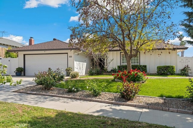 ranch-style house featuring fence, a garage, board and batten siding, a front yard, and concrete driveway