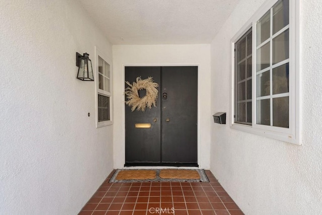 view of exterior entry with stucco siding