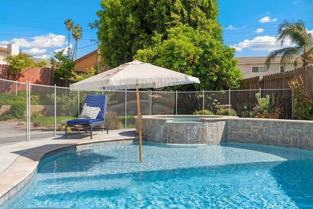 view of pool featuring a fenced backyard and a pool with connected hot tub