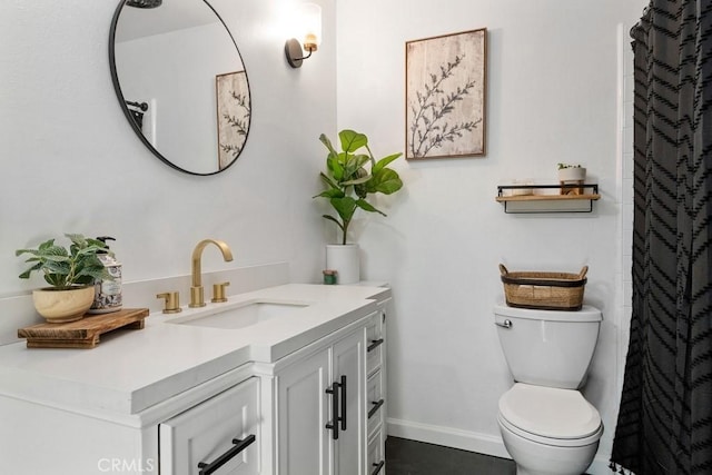 bathroom featuring vanity, baseboards, curtained shower, and toilet