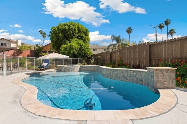 view of swimming pool featuring a fenced backyard and a pool with connected hot tub