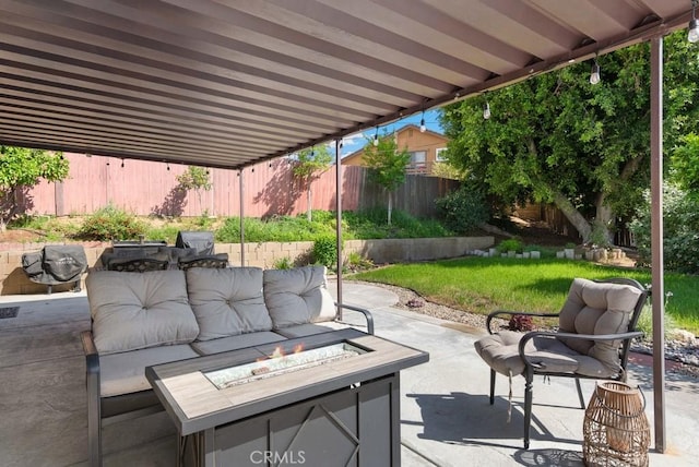 view of patio / terrace featuring fence private yard and an outdoor living space with a fire pit