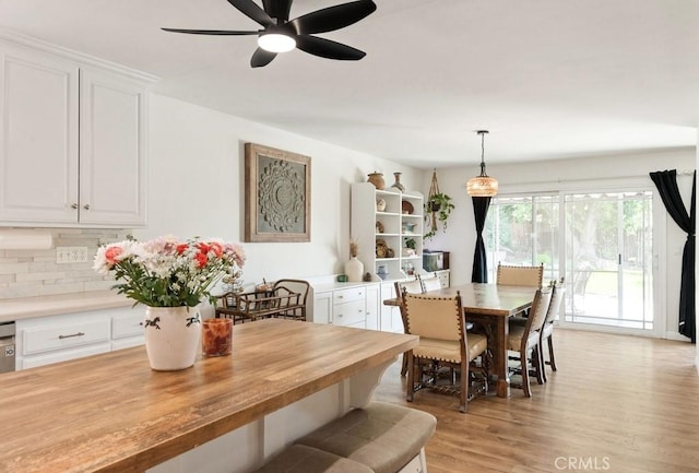 dining area featuring a ceiling fan and light wood-style flooring