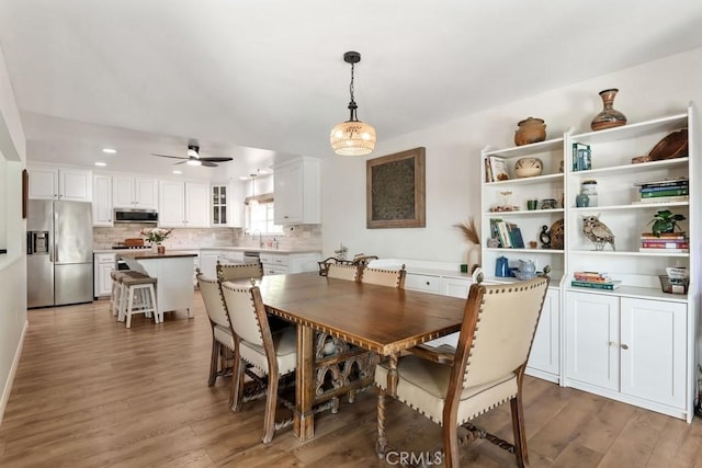 dining space with recessed lighting, a ceiling fan, and light wood finished floors