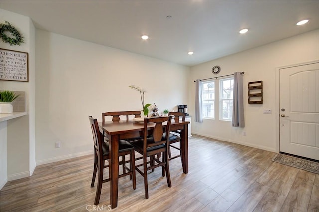dining room with light wood-style floors, baseboards, and recessed lighting