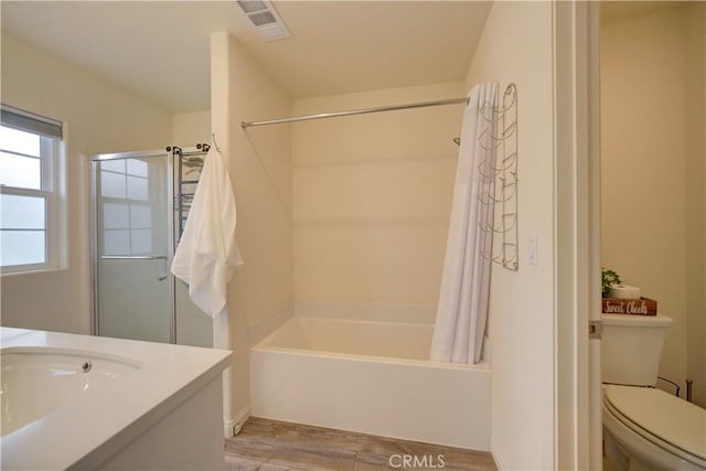 bathroom with wood finished floors, shower / bath combo with shower curtain, toilet, and vanity