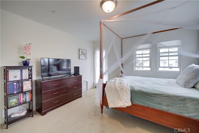 bedroom with light carpet and vaulted ceiling
