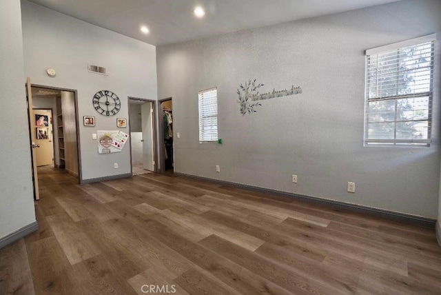 21269 Cottonwood Ln, Walnut, CA 91789 - unfurnished room featuring visible vents, baseboards, recessed lighting, a towering ceiling, and wood finished floors