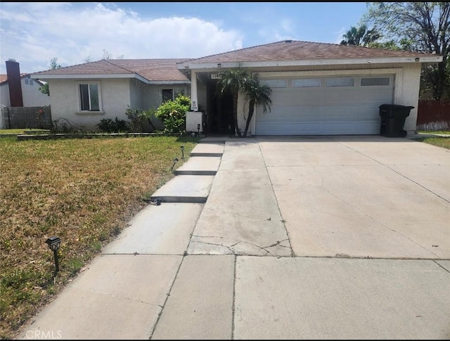 2145 Grand Ave, San Bernardino, CA 92407 - ranch-style home with stucco siding, driveway, and an attached garage